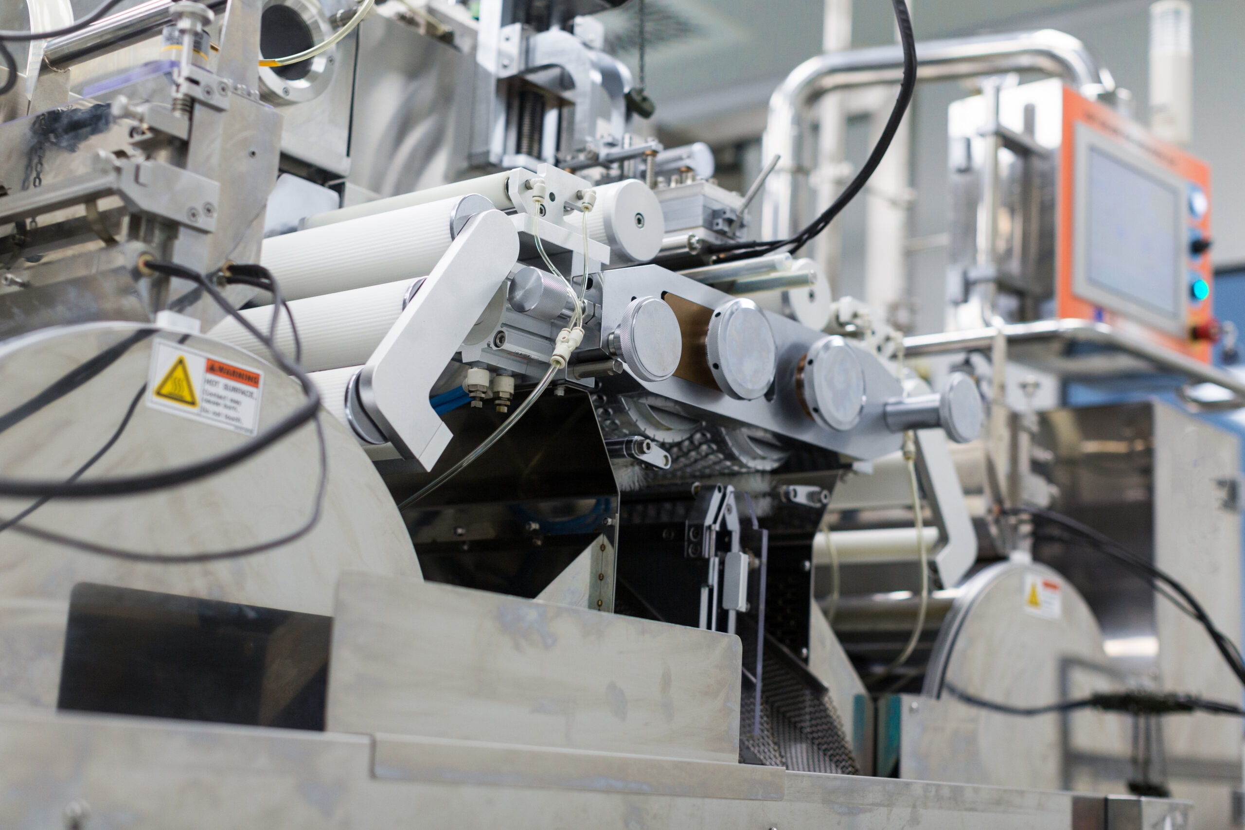 big steel chromed manufacture machine with shafts and computer control panel, from bellow